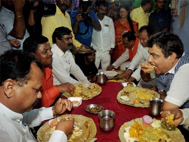 File image of Union minister Nitin Gadkar having a meal at a Dalit family's house in Ranchi. PTI.