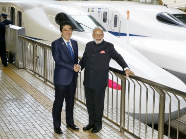 Narendra Modi and Shinzo Abe pose in front of a Shinkansen Bullet train at Tokyo Station. Reuters