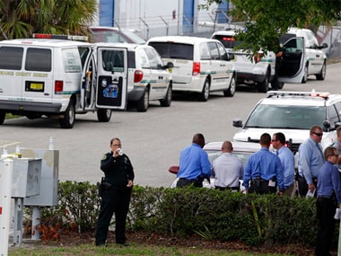 Police vehicles line up outside the scene of a shooting where there were five were killed in an industrial area near Orlando. AP