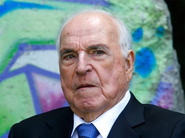 The May 16, 2014 photo shows former German Chancellor Helmut Kohl in front of a piece of the Berlin Wall in Kohl's garden in Oggersheim near Ludwigshafen, Germany. AP