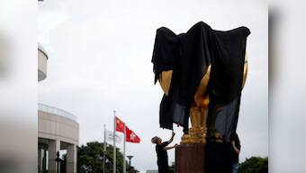 Ahead of Xi Jinping's visit to Hong Kong, pro-democracy activists drape city's emblem with black flag