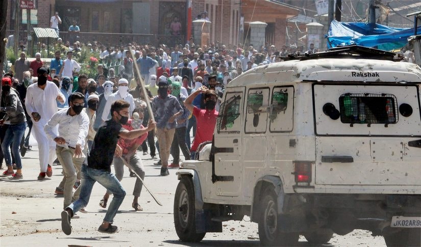 Kashmiri youths damage a police jeep in Srinagar on Friday. PTI