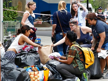 People donate articles of food, clothing and household items for those made homeless by the massive fire in Grenfell Tower, in London, Thursday