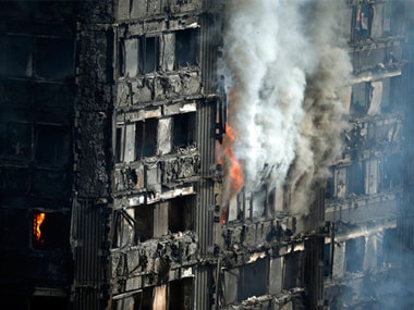 Parts of the building still burn hours after a deadly blaze at a high rise apartment block in London, Wednesday. AP