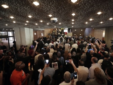 Protests at a public meeting about the London fire. AP