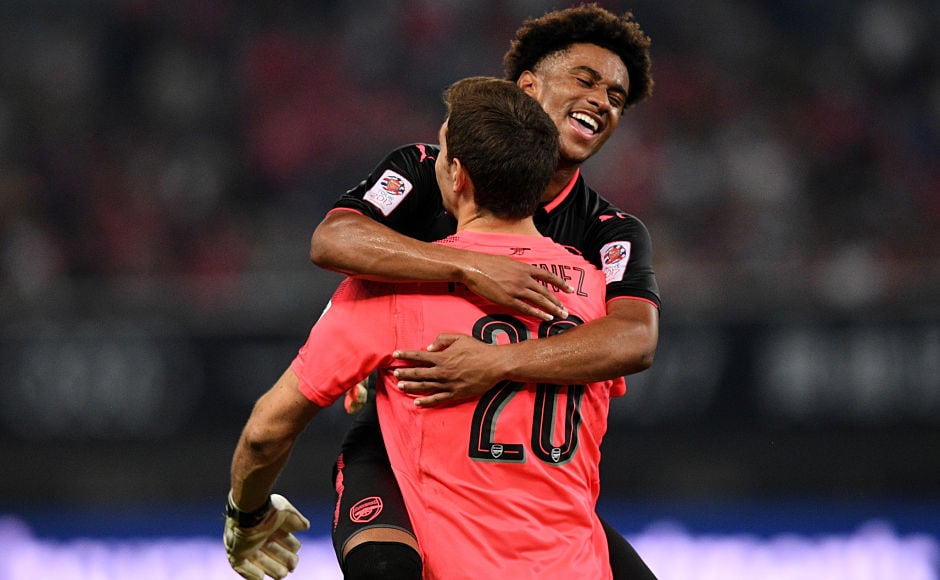 Arsenal player Reiss Nelson and Arsenal's goalkeeper Emiliano Martinez reacts after the penalty shoot out during the International Champions Cup football match between Bayern Munich and Arsenal in Shanghai July 19, 2017. / AFP PHOTO / Johannes EISELE