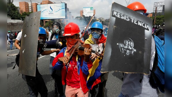 'Symphony of protests' across Venezuela as violinist's musical resistance goes viral