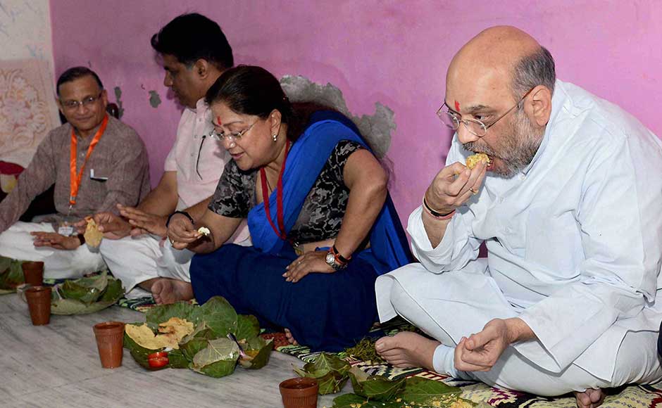 They were served food by Pacharia's family and had lunch sitting on the ground. They were served food by Pacharia's family and had lunch sitting on the ground.