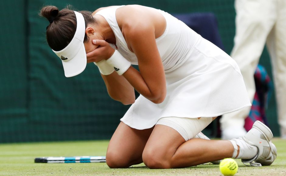 Muguruza fell to the floor in celebration after clinching victory in an hour and 17 minutes. Reuters Muguruza fell to the floor in celebration after clinching victory in an hour and 17 minutes. Reuters