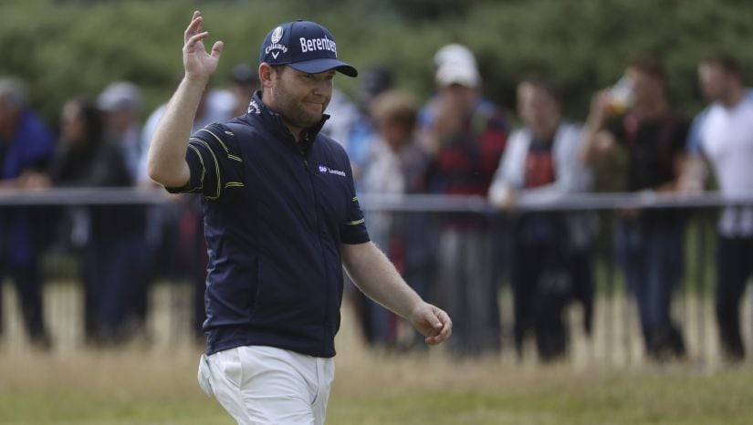 South Africa's Branden Grace waves as he makes his way along the 18th fairway during the third round of the British Open. AP