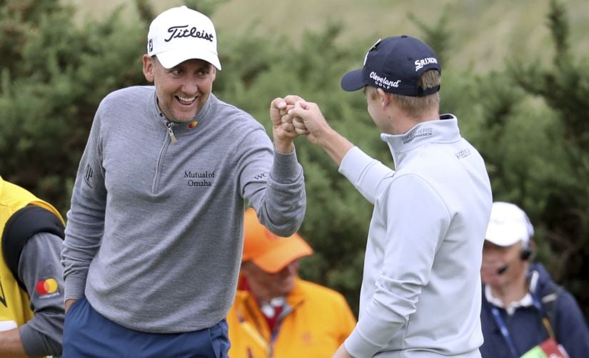 Ian Poulter, left, and Russell Knox congratulate each other on their long putts on the 9th hole during the second round of the British Open. AP