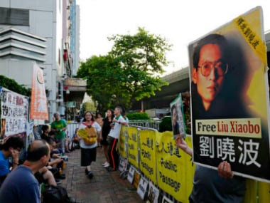 Protesters display pictures of jailed Chinese Nobel Peace laureate Liu Xiaobo. AP