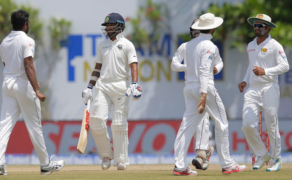 India's Shikhar Dhawan, second leaves the pitch after being dismissed by Sri Lanka's Dilruwan Perera. AP