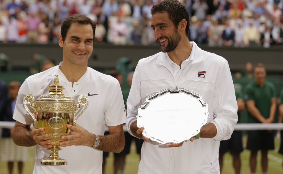 Federer holds the winners trophy alongside Cilic, with the runners up plate. AP Federer holds the winners trophy alongside Cilic, with the runners up plate. AP