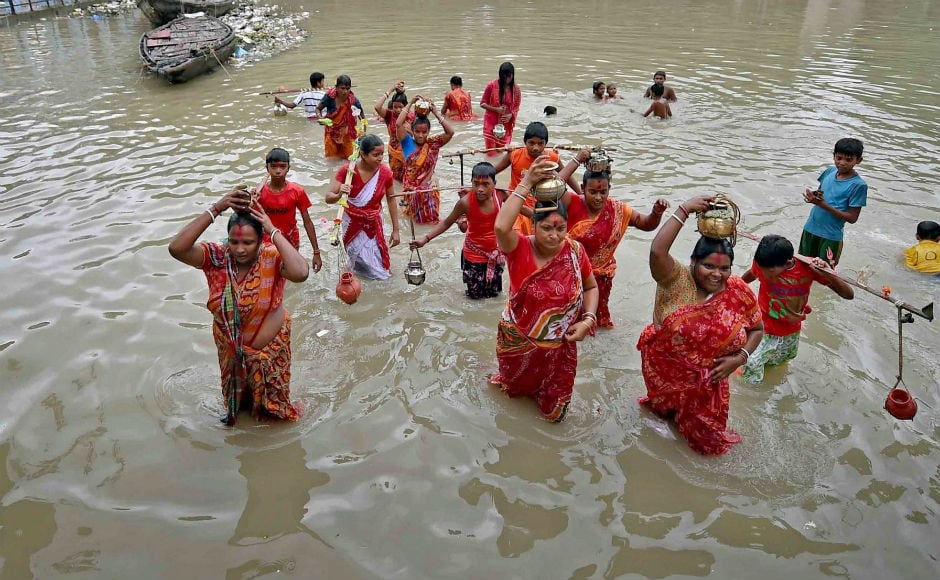 In Kolkata, devotees took a holy dip in the river Ganga before start of thier journey to Tarakeshwar Temple to offer puja. PTI