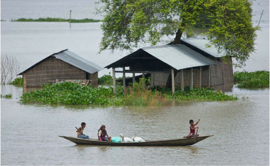 A boy rows a boat to cross flood waters at Burgaon, 80 kilometres east of Guwahati in Assam on Thursday. AP A boy rows a boat to cross flood waters at Burgaon, 80 kilometres east of Guwahati in Assam on Thursday. AP