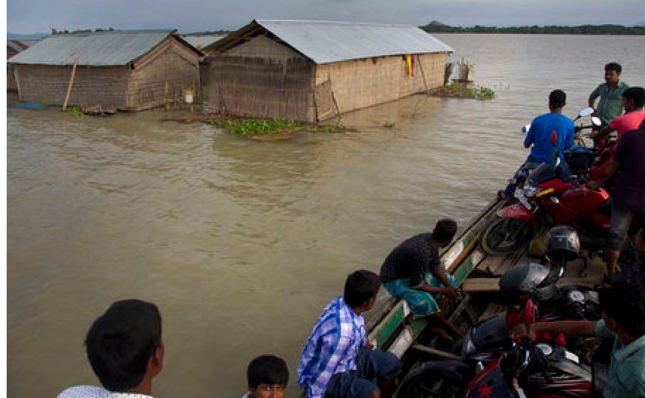 Daily commuters wade through flood waters in Assam. Over 3.5 lakh people have been affected in 13 districts of the state. Reuters Daily commuters wade through flood waters in Assam. Over 3.5 lakh people have been affected in 13 districts of the state. Reuters