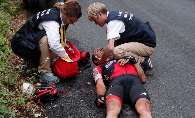 Australia's Richie Porte gets medical assistance after crashing in the descent of the Mont du Chat pass during the ninth stage of the Tour de France cycling race over 181.5 kilometers (112.8 miles) with start in Nantua and finish in Chambery, France, Sunday, July 9, 2017. (AP Photo/Christophe Ena)