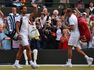 Rafael Nadal (L) reacts after losing to Gilles Muller at Wimbledon. AFP