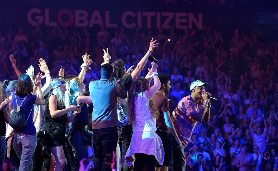 Singer Pharrell Williams, right, performs at the Global Citizen Festival concert on the eve of the G-20 summit in Hamburg, northern Germany, Thursday, July 6, 2017. The leaders of the group of 20 meet July 7 and 8. (AP Photo/Jens Meyer)