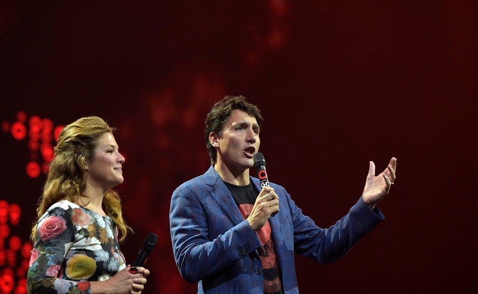 Canada's Prime Minister Justin Trudeau, right, speaks to the crowd during the Global Citizen Festival concert on the eve of the G-20 summit in Hamburg, northern Germany, Thursday, July 6, 2017. The leaders of the group of 20 meet July 7 and 8. (AP Photo/Jens Meyer)