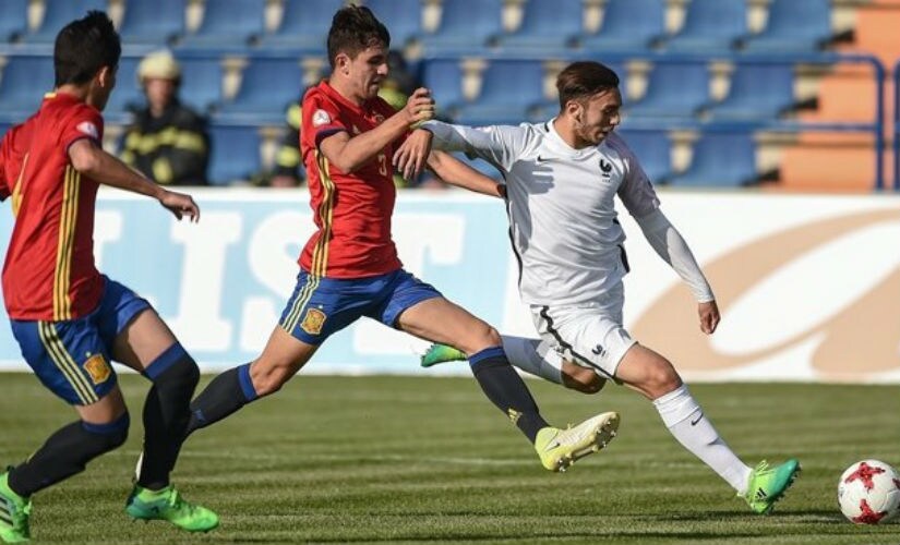 Amine Gouiri of France (R) shoots to score his side's first goal during their UEFA European Under-17 Championship quarter-final match. UEFA