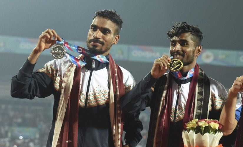 Gopi Thonakal (L) and G Lakshmanan (R) pose with thier silver and gold medals after men's 10,000m event. PTI
