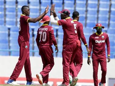 West Indies’ bowler Alzarri Joseph (left) celebrates with Rovman Powell dismissing India’s Dinesh Karthik during their fourth ODI. AP
