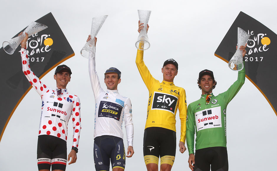 Tour de France winner Britain's Chris Froome, wearing the overall leader's yellow jersey, Australia's Michael Matthews, wearing the best sprinter's green jersey, France's Warren Barguil, wearing the best climber's dotted jersey and Britain's Simon Yates, wearing the best young rider's white jersey,on the podium after the last stage of the cycling race. AP Tour de France winner Britain's Chris Froome, wearing the overall leader's yellow jersey, Australia's Michael Matthews, wearing the best sprinter's green jersey, France's Warren Barguil, wearing the best climber's dotted jersey and Britain's Simon Yates, wearing the best young rider's white jersey,on the podium after the last stage of the cycling race. AP