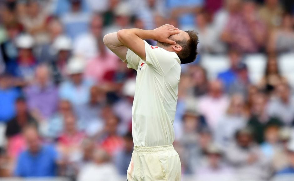 England's Mark Wood covers his face as South Africa continue to pile the runs and misery ofn the home side. AFP