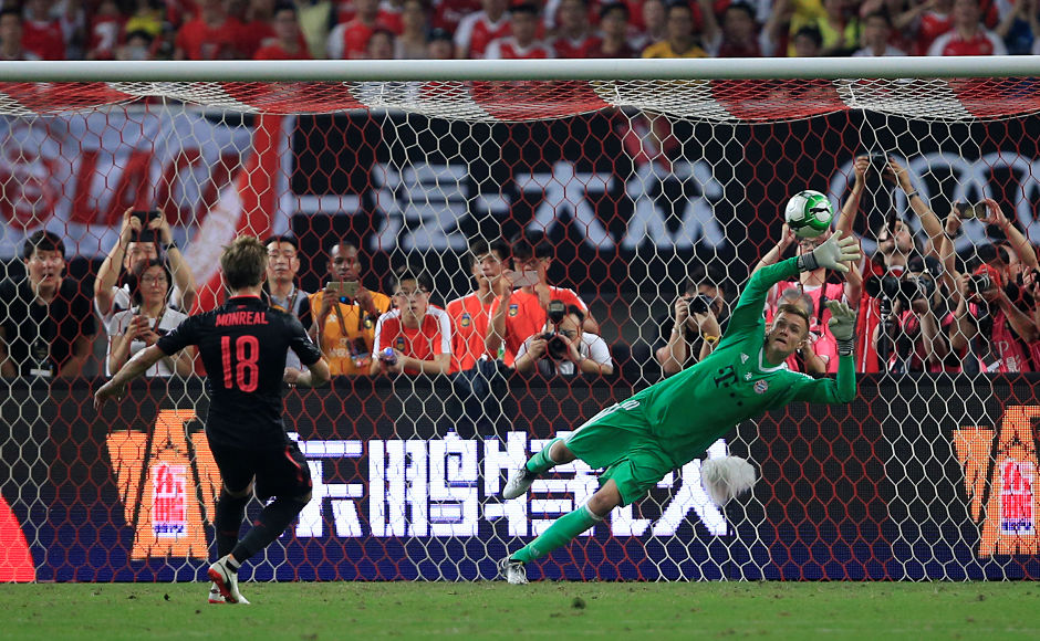 Arsenal's Nacho Monreal fires from the spot kick during the penalty shootout . Reuters