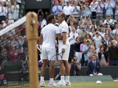 Gilles Muller, right, with Rafael Nadal after winning their fourth round match. AP