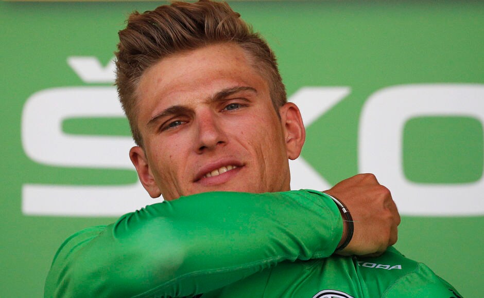 Germany's sprinter Marcel Kittel, wearing the best sprinter's green jersey, celebrates on the podium after the third stage of the Tour de France cycling race. AP Germany's sprinter Marcel Kittel, wearing the best sprinter's green jersey, celebrates on the podium after the third stage of the Tour de France cycling race. AP