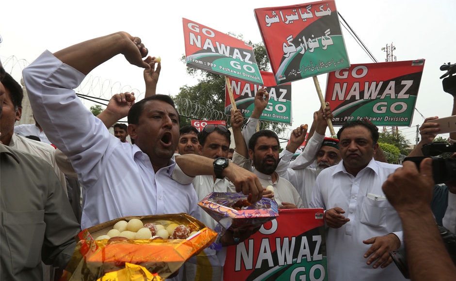 Supporters of opposition parties share sweets to celebrate the Nawaz Sharif's dismissal in Peshawar, Pakistan. Opposition party members began chanting 'Go, Nawaz, Go' after the Supreme Court verdict was announced. AP Supporters of opposition parties share sweets to celebrate the Nawaz Sharif's dismissal in Peshawar, Pakistan. Opposition party members began chanting 'Go, Nawaz, Go' after the Supreme Court verdict was announced. AP