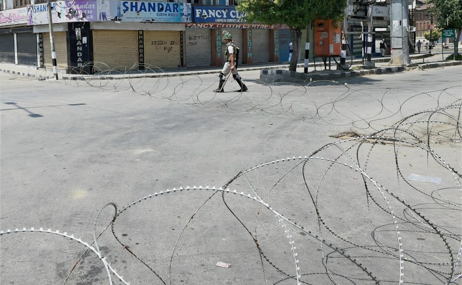 A security personnel stands in a deserted area in Srinagar on Sunday. PTI A security personnel stands in a deserted area in Srinagar on Sunday. PTI