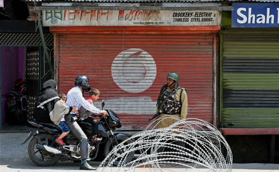 A motorcyclist and his family crossing a barricade set up by security forces during a strike in Srinagar on Sunday. A restriction was imposed in parts of Srinagar after the killing of two civilians in Anantnag in South Kashmir on Sunday. PTI A motorcyclist and his family crossing a barricade set up by security forces during a strike in Srinagar on Sunday. A restriction was imposed in parts of Srinagar after the killing of two civilians in Anantnag in South Kashmir on Sunday. PTI