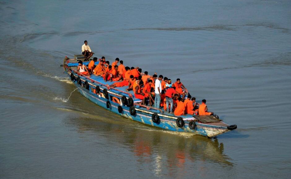 Guwahati: Kanwariyas travelling in a boat at river Brahmaputra in Guwahati on Monday. PTI 