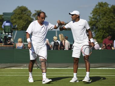 India's Purav Raja (L) and Divij Sharan (R) touch hands between points during their men's doubles first round match against Britain's Kyle Edmund and Brazil's Joao Sousa on the third day of the 2017 Wimbledon Championships at The All England Lawn Tennis Club in Wimbledon, southwest London, on July 5, 2017. / AFP PHOTO / Oli SCARFF / RESTRICTED TO EDITORIAL USE