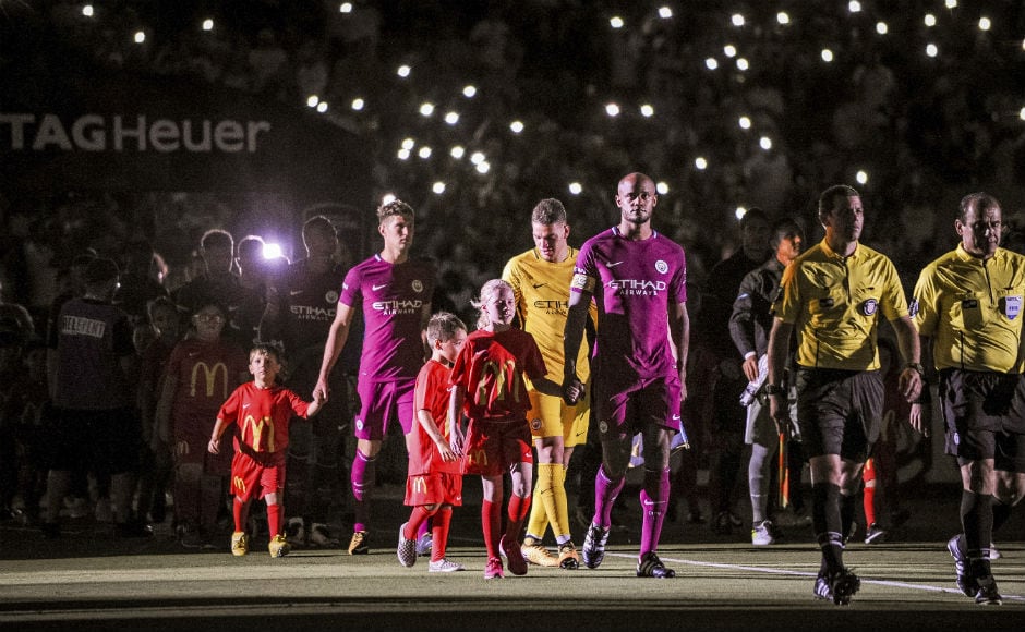 Manchester City and Real Madrid take to the field during the opening ceremony at the Los Angeles Memorial Coliseum. AP Manchester City and Real Madrid take to the field during the opening ceremony at the Los Angeles Memorial Coliseum. AP