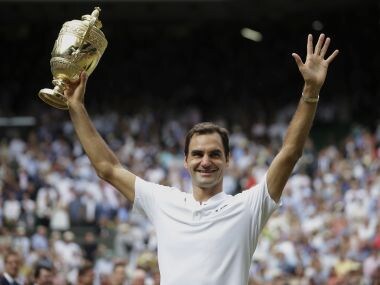 Roger Federer celebrates with the trophy after beating Marin Cilic in the Wimbledon final. AP
