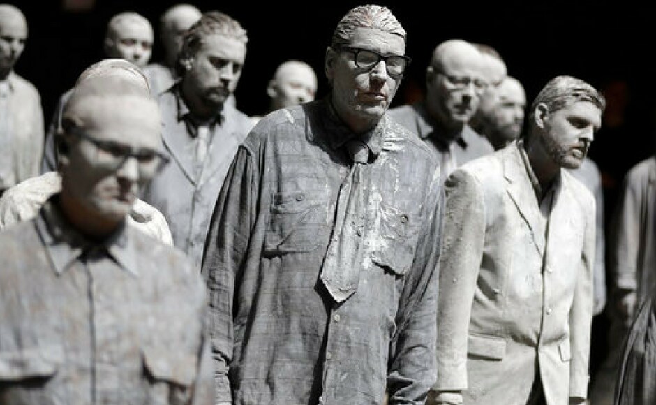 Hundreds of people painted like clay figures move slowly and silently through the streets of Hamburg to protest against the G20 summit in Hamburg, northern Germany on Wednesday. AP Hundreds of people painted like clay figures move slowly and silently through the streets of Hamburg to protest against the G20 summit in Hamburg, northern Germany on Wednesday. AP