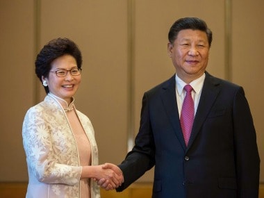 Xi Jinping, China's president, shakes hands with Carrie Lam on Friday. AP