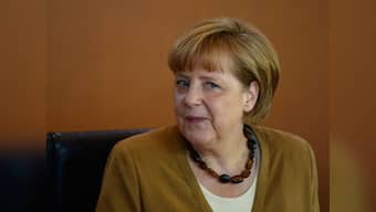 Angela Merkel agrees to cap Germany's refugee intake at 200,000 a year; seeks to unite allies ahead of tough coalition talks