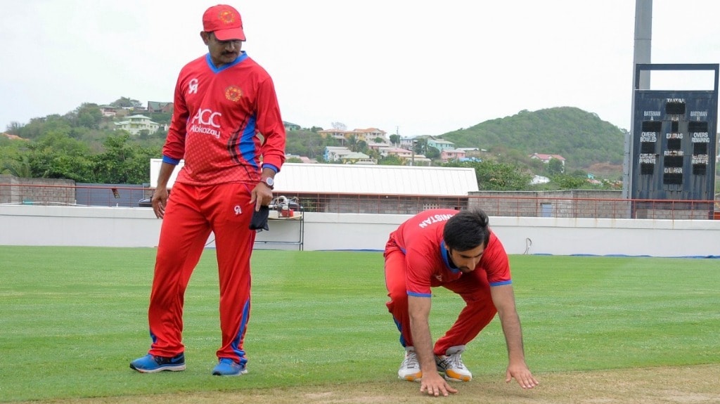 Lalchand Sitaram Rajput of Afghanistan (L) watches as teammate Mohamad Asghar Stanikzai (R) of Afghanistan inspects the pitch during a training session at Darren Sammy National Cricket Stadium on 8 June 2017 in St. Lucia ahead of the West Indies vs Afghanistan ODI game scheduled on 9 June 2017 — AFP PHOTO
