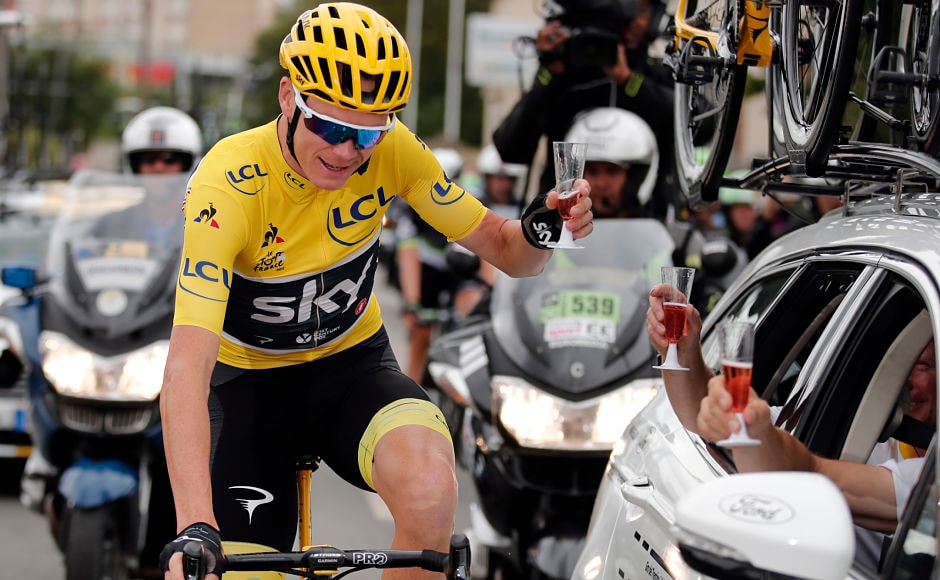 Froome, raises a toast to the members and technicians behind his fourth Tour de France victory. AP Froome, raises a toast to the members and technicians behind his fourth Tour de France victory. AP