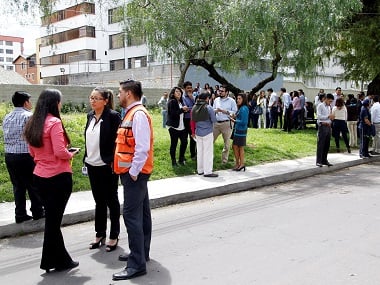 People gather on the streets minutes after a tremor was felt in Quito. Reuters