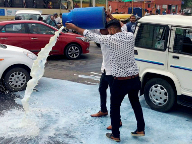 Farmers' unrest: Gujarat agitators empty milk cans demanding farm loan waiver Farmers' unrest: Gujarat agitators empty milk cans demanding farm loan waiver