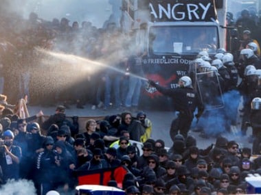 A Police officer sprays a liquid during a protest against the G-20 summit in Hamburg, northern Germany. AP