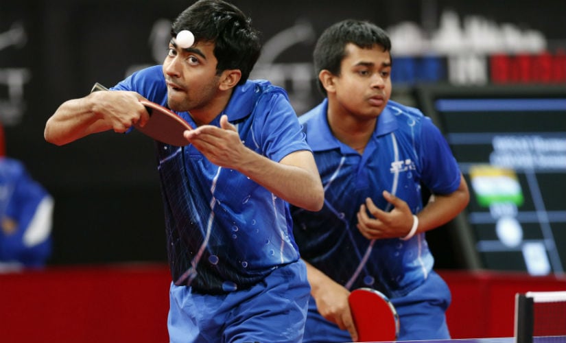 Harmeet Desai (L) and Soumyajit Ghosh (R) serve to Taiwan's Wu Chih-chi and Lee Chia-Sheng during their men's double qualifying rounds at the World Team Table Tennis Championships in Paris May 14, 2013. Reuters