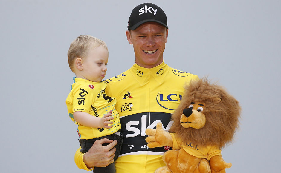Froome holds his son Kellan on the podium after the twenty-first and last stage of the Tour de France. AP Froome holds his son Kellan on the podium after the twenty-first and last stage of the Tour de France. AP